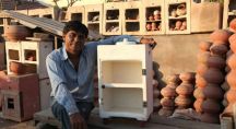 un indien est devant un frigo en argile qui fonctionne sans électricité